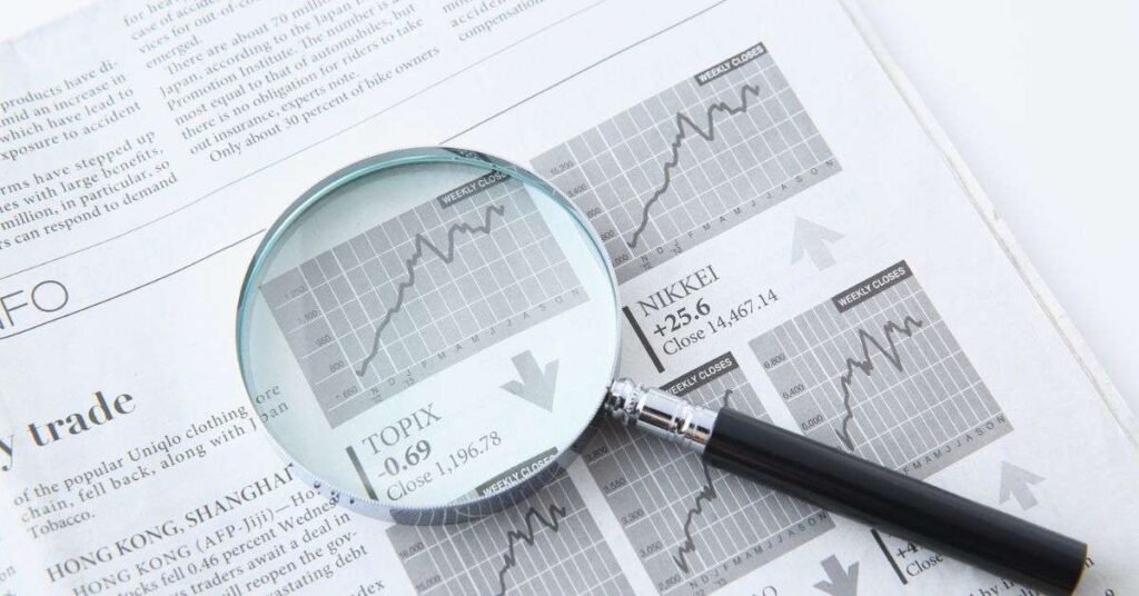 stocks betterthisworld market analysis research concept with charts and magnifying glass