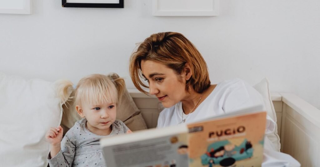 Mother reading book with young child.